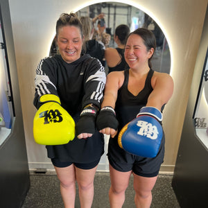 two girls wearing boxing gloves 