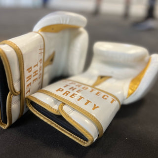 white and gold boxing gloves