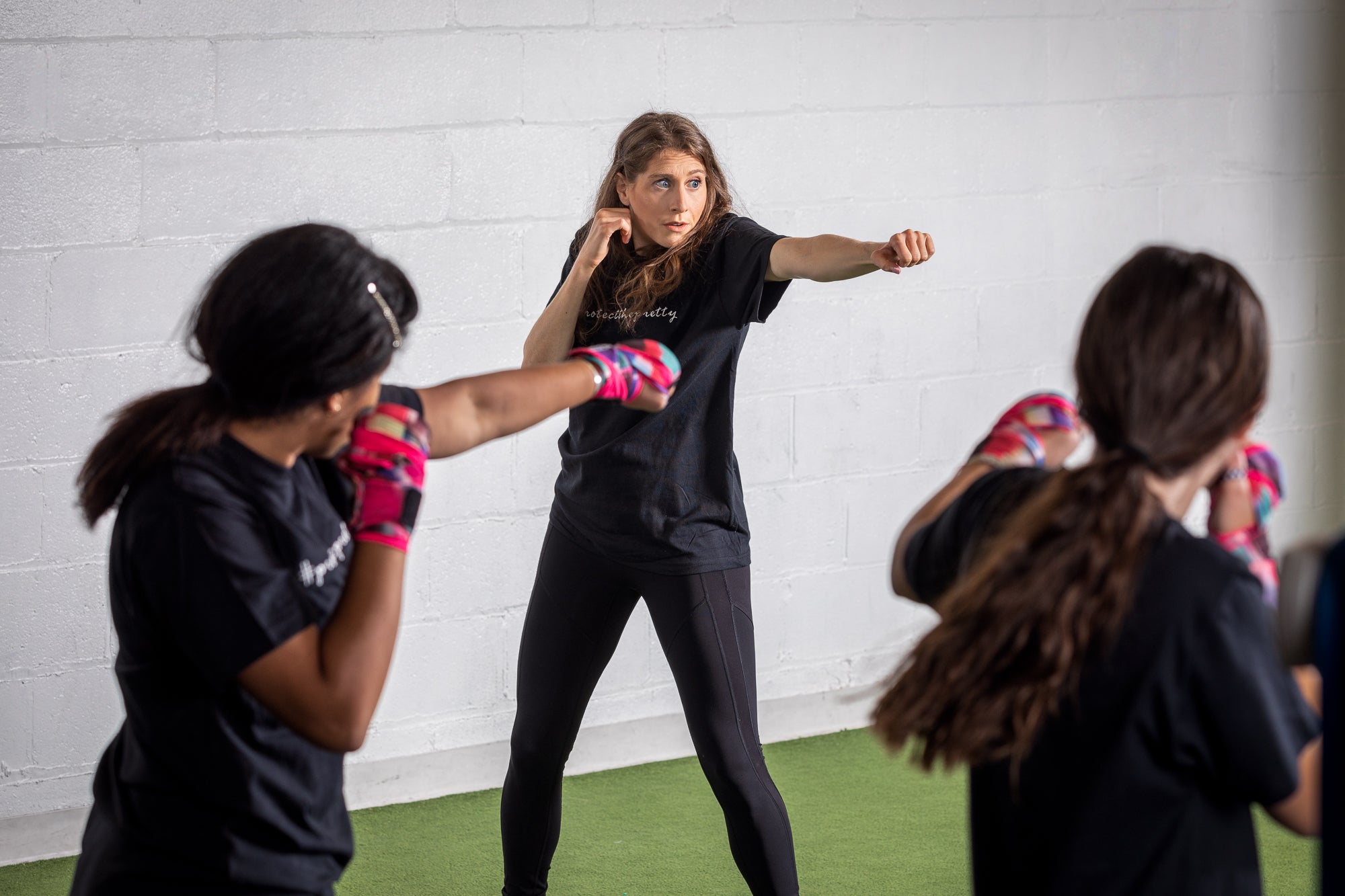boxing coach: helene instructing teen girls 
