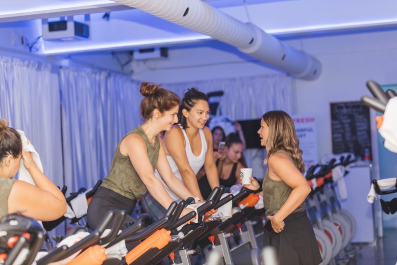 girls on spin bikes at a fitness event 