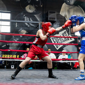 2 boxers in a the ring punching each other