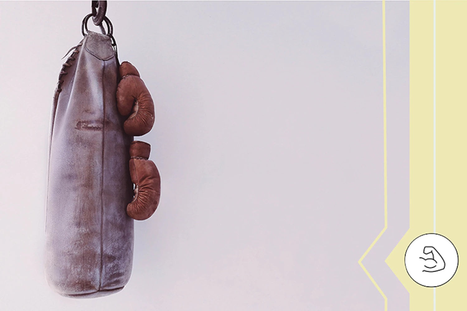 old boxing bag and gloves hanging off 