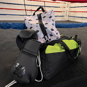 girls just wanna box small shoe bag, boxing gloves and neon yellow and black gym bag in a boxing ring 