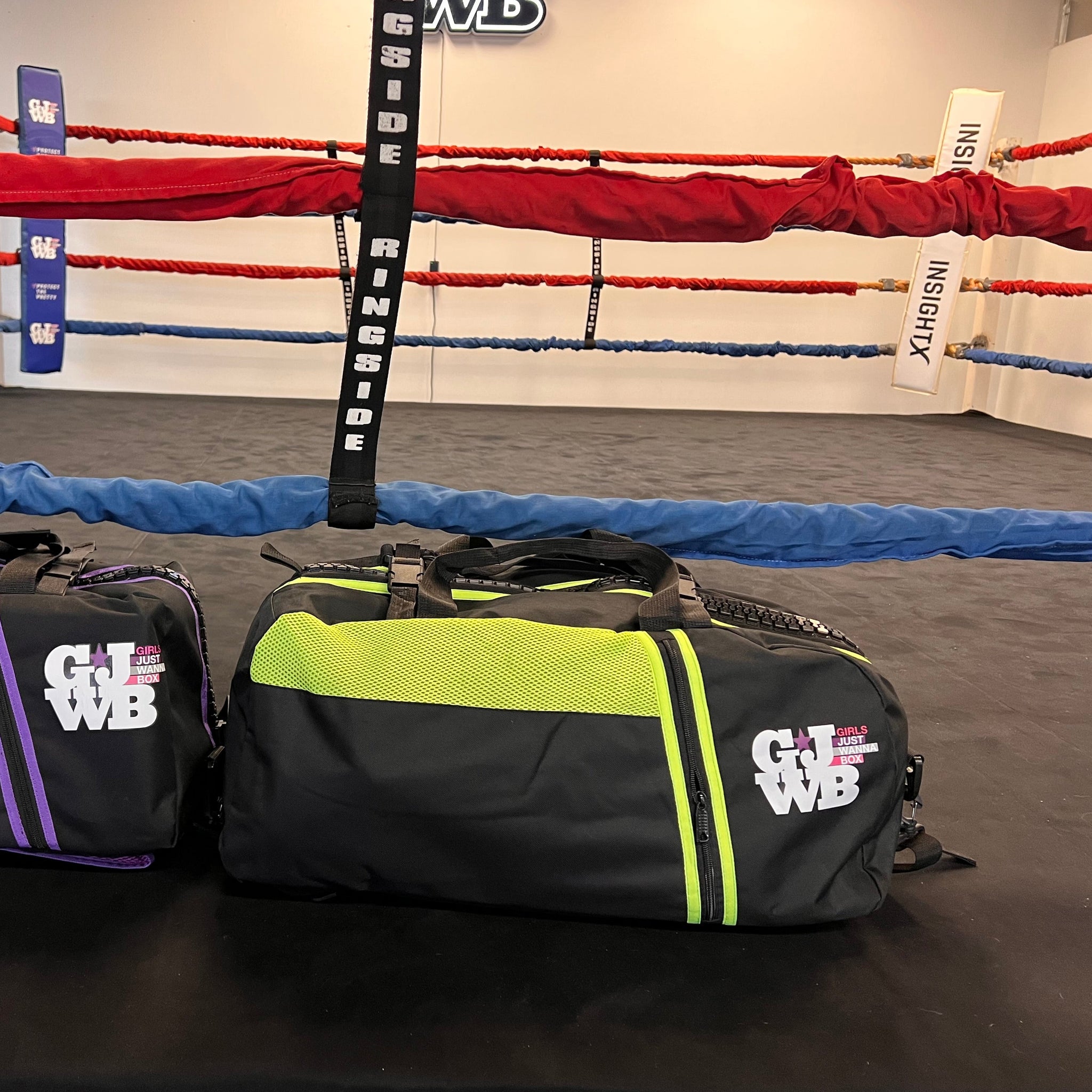 purple and black and neon yellow and black gymbag inside a boxing ring 