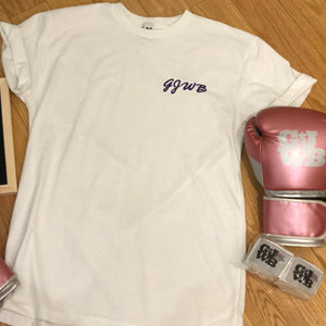 A flat lay with a white Girls Just Wanna Box boyfriend tshirt, pink GJWB boxing gloves, hand wraps and a sign that reads "XO Girls Just Wanna Box"