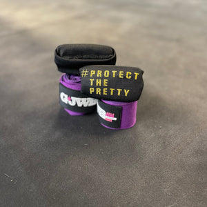 GJWB black knuckle protectors for boxers to use on their hands with purple wraps underneath 