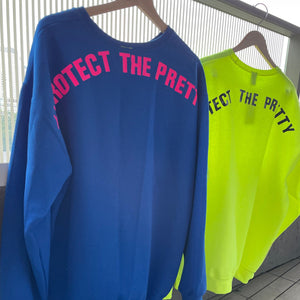 blue and neon yellow sweaters on a hanger outside with saying #protectthepretty 