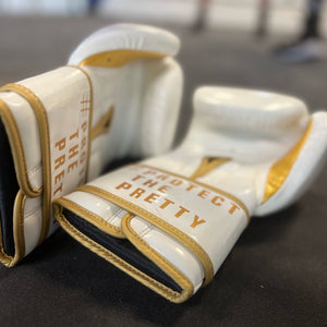 white and gold boxing gloves 