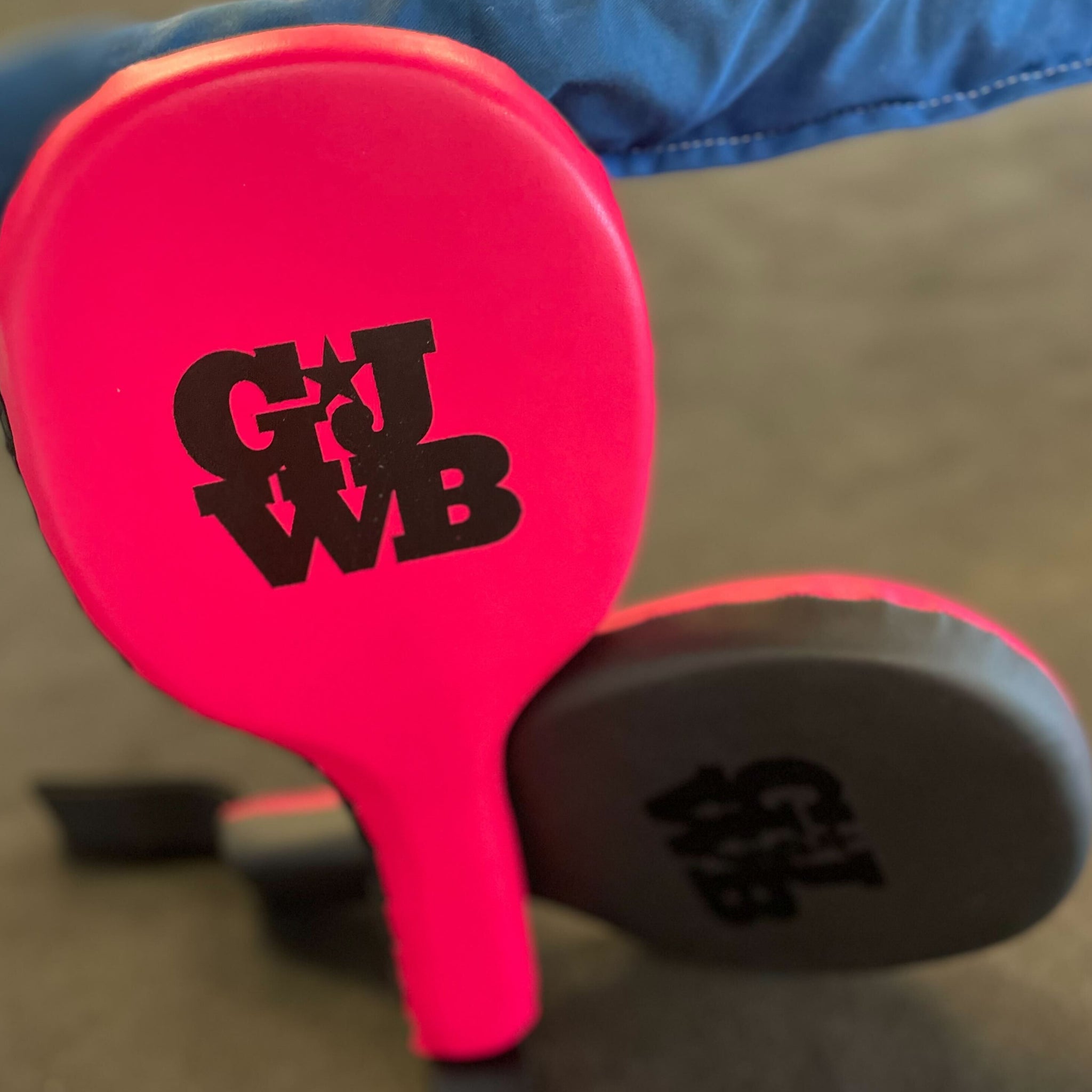 Pink and Black women's boxing coaching paddles with GJWB logo