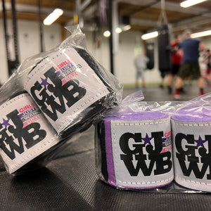 black and purple cotton handwraps for boxing with people boxing in the background
