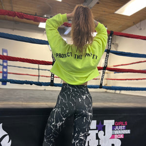 girl with crop sweater saying #protectthepretty in front of a boxing ring 